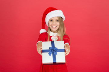 Cheerful kid carnival costume red background. Surprise for her. Happy winter holidays. Small girl opening gift. New year. Santa claus gift. Little girl child received gift. Present xmas. Magic moment