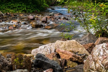 river with a stream and pebbles