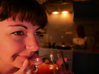 Girl dreams sitting with a glass mug of tea in the evening, close-up, copy space