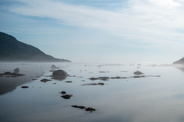 bay with rocks and mist