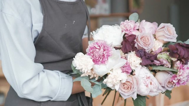 Florist making fresh flower bouquet in flower shop