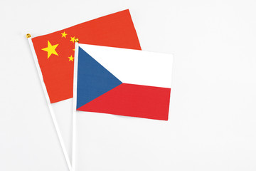 Czech Republic and China stick flags on white background. High quality fabric, miniature national flag. Peaceful global concept.White floor for copy space.