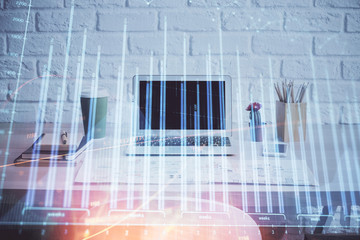 Obraz premium Stock market chart hologram drawn on personal computer background. Double exposure. Concept of investment.