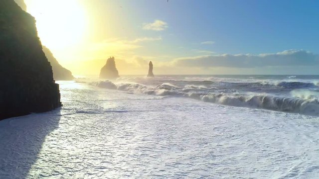 Huge waves crashing and splashing on a Black Beach in Iceland. Aerial view of Atlantic ocean on sunrise