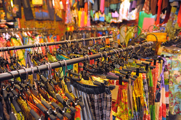 Obraz premium Colorful skirts hanging in Indian shop. Warm colors