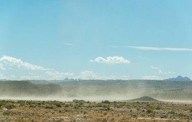 Dust and winds at foreground under a blue sky