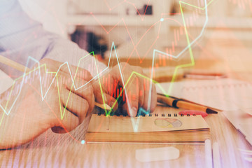 Multi exposure closeup hands with stock market forex graph.
