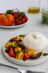 Salad with italian burrata cheese, fresh ripe tomatoes and basil