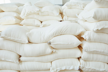 Many white bags in warehouse.