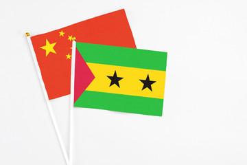 Sao Tome And Principe and China stick flags on white background. High quality fabric, miniature national flag. Peaceful global concept.White floor for copy space.