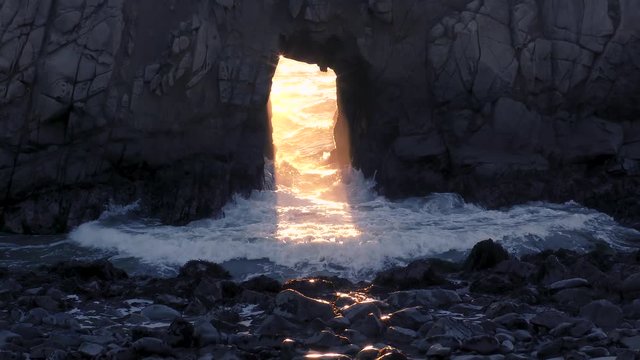 Magical warm orange waves wash over the cold blue and teal shaded stones creating an ethereal and surreal experience of this natural wonder of Nature off the Pacific coast of Western California. 