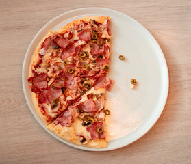 half pizza on a round plate with place for text
