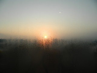  Drops of dew on the glass backlit by the morning sun.