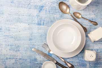 Top view on rustic table arrangement of different dishes and utensils with space for text