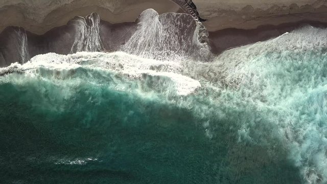 Aerial top down shot of ocean waves on sandy baech. Monte Verde, Ribeira Grande, S&atilde;o Miguel Island, Azores