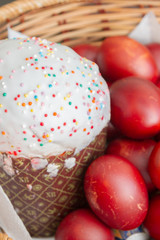 Easter spring cake with painted chicken eggs in a wicker basket