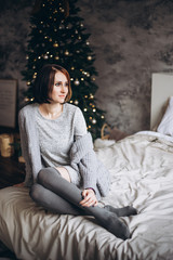 Fototapeta premium young woman relaxing on her bed at Christmas