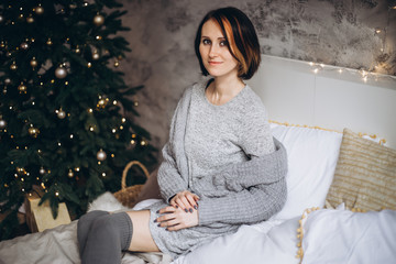 Portrait of a young woman during preparations for Christmas at home
