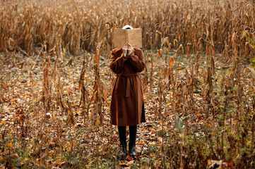 Style woman with book on corn field in autumn time season