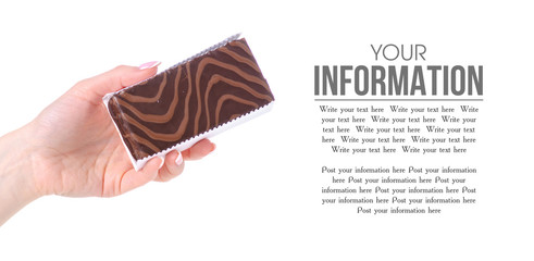 Chocolate cake biscuit in hand on a white background. Isolation, space for text