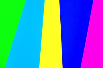 Vibrant colored rubber mats layered vertically to make a rainbow color background.