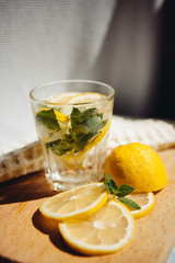 Fresh lemonade drink or mojito cocktail with lemon, mint and ice, summer still life