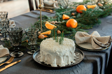 Christmas white cake on a table with pine branches