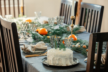 Christmas white cake on a table with pine branches
