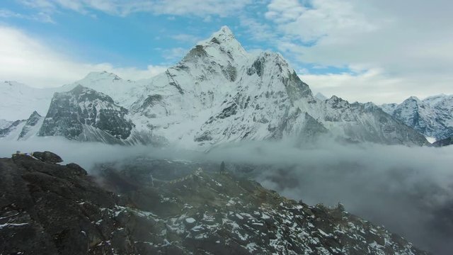 Man Looking on Ama Dablam Mountain. Himalaya, Nepal. Aerial View. Drone Flies Forward