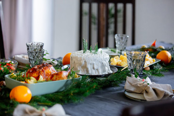 Christmas white cake on a table with pine branches