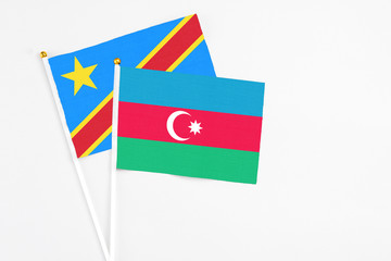 Azerbaijan and Congo stick flags on white background. High quality fabric, miniature national flag. Peaceful global concept.White floor for copy space.