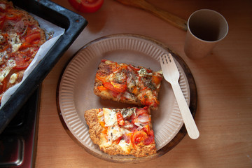 homemade pizza on a baking sheet, disposable tableware, concept zero plastic
