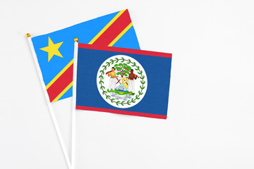 Belize and Congo stick flags on white background. High quality fabric, miniature national flag. Peaceful global concept.White floor for copy space.