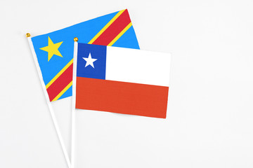 Chile and Congo stick flags on white background. High quality fabric, miniature national flag. Peaceful global concept.White floor for copy space.