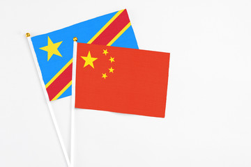 China and Congo stick flags on white background. High quality fabric, miniature national flag. Peaceful global concept.White floor for copy space.