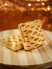 One apple lattice on a wooden board, warm tones, blurred brown background. Close up, Selective focus. Pastry product.