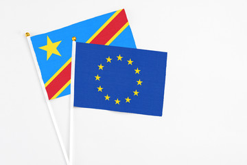 European Union and Congo stick flags on white background. High quality fabric, miniature national flag. Peaceful global concept.White floor for copy space.