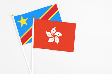 Hong Kong and Congo stick flags on white background. High quality fabric, miniature national flag. Peaceful global concept.White floor for copy space.