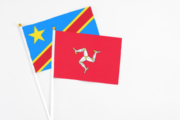 Isle Of Man and Congo stick flags on white background. High quality fabric, miniature national flag. Peaceful global concept.White floor for copy space.