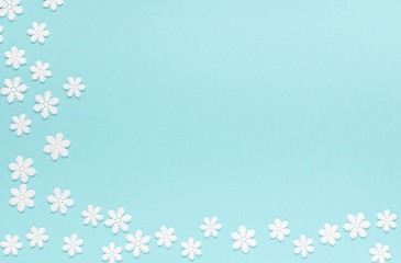Fototapeta na wymiar Holiday pastel background, white snowflakes on a gentle blue background ,flat lay, top view