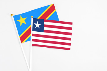 Liberia and Congo stick flags on white background. High quality fabric, miniature national flag. Peaceful global concept.White floor for copy space.