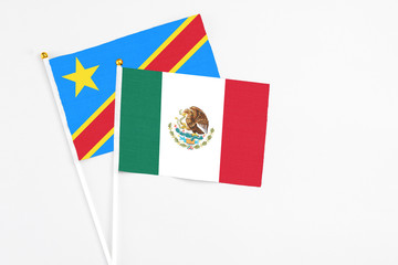 Mexico and Congo stick flags on white background. High quality fabric, miniature national flag. Peaceful global concept.White floor for copy space.