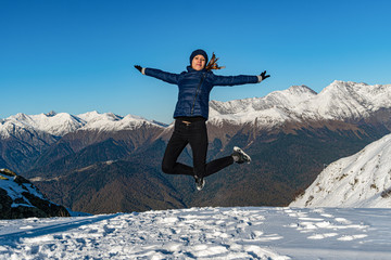 Happy woman are jumping on the top of mountain