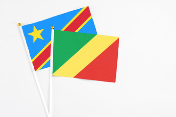 Republic Of The Congo and Congo stick flags on white background. High quality fabric, miniature national flag. Peaceful global concept.White floor for copy space.