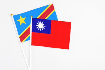 Taiwan and Congo stick flags on white background. High quality fabric, miniature national flag. Peaceful global concept.White floor for copy space.