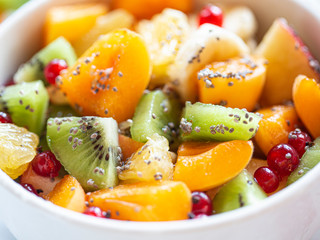 Healthy summer Breakfast concept, fruit salad in  a white bowl. Vegetarian food concept. Weight loss concept.