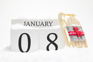 Wooden calendar for January, 8 th day of the winter month. The symbols of winter are snow and sleigh. Concept of holidays, vacation and winter fun.