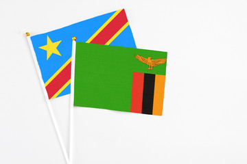 Zambia and Congo stick flags on white background. High quality fabric, miniature national flag. Peaceful global concept.White floor for copy space.