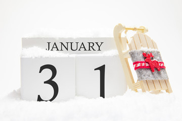 Wooden calendar for January, 31 st day of the winter month. The symbols of winter are snow and...