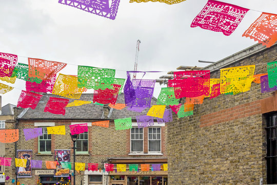 Street view with colorful flags at Columbia Road Flower Market in London